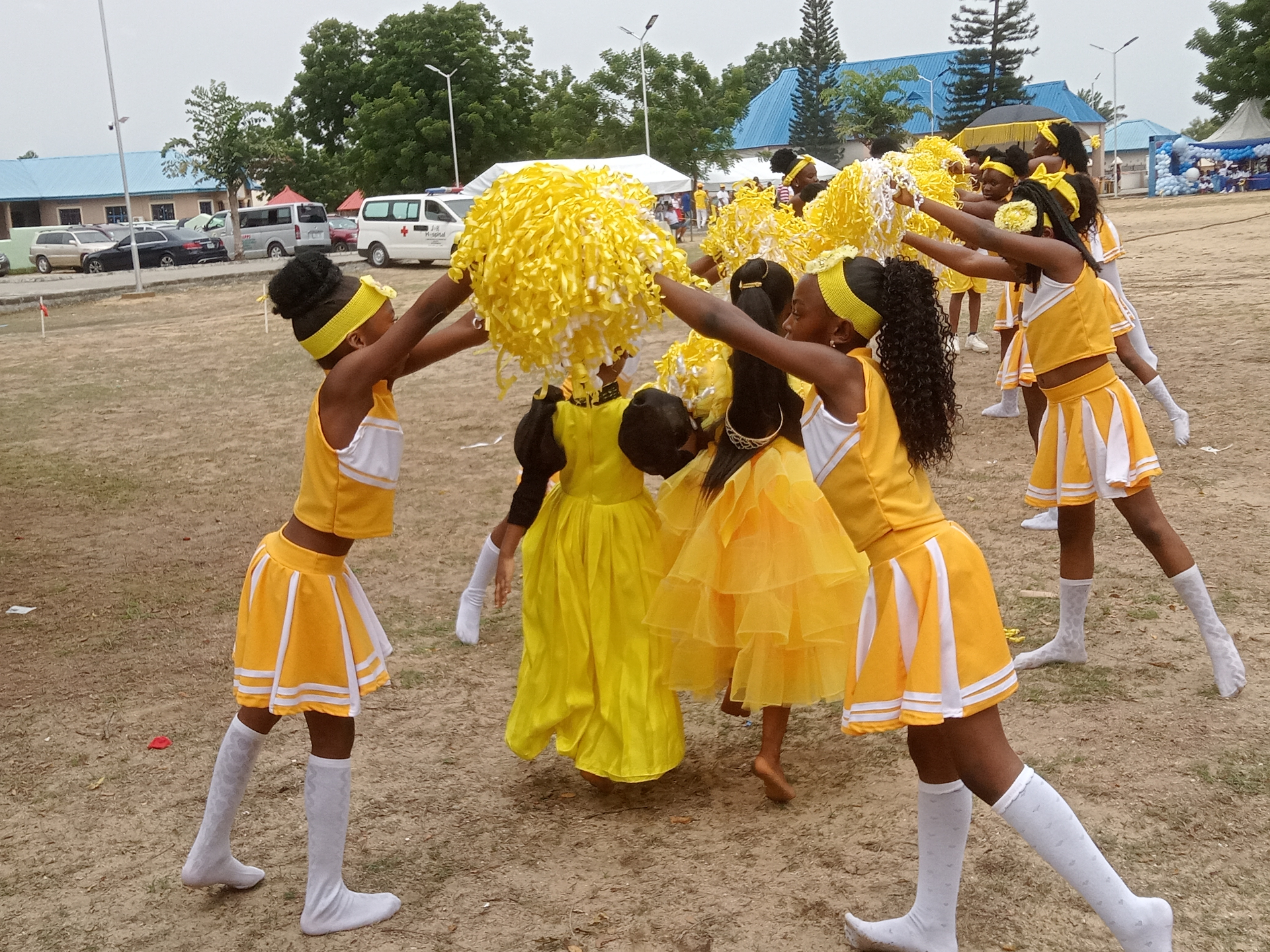 Pedrisi cheerleaders performing in yellow uniforms