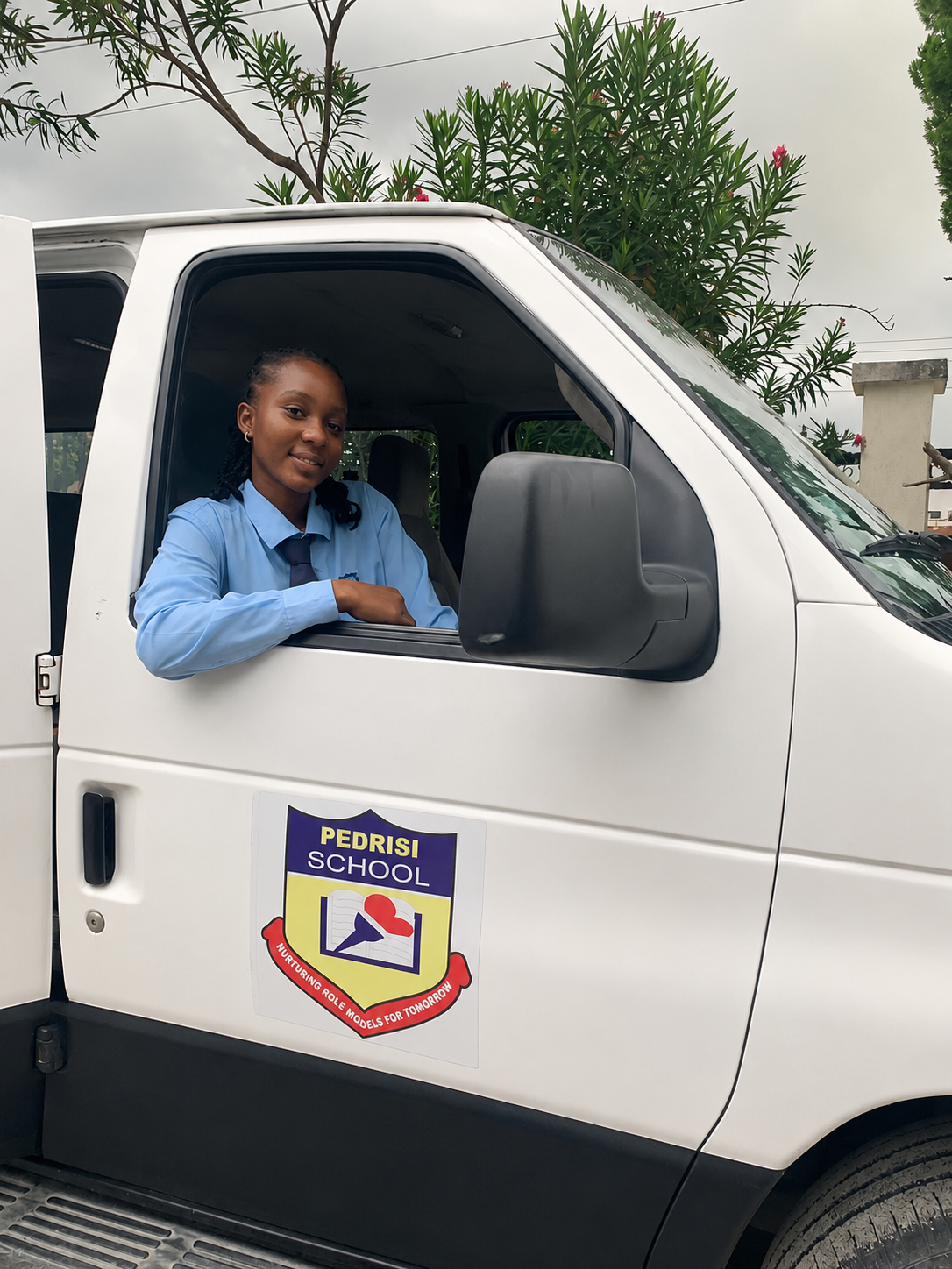 Pedrisi student smiling from the school van