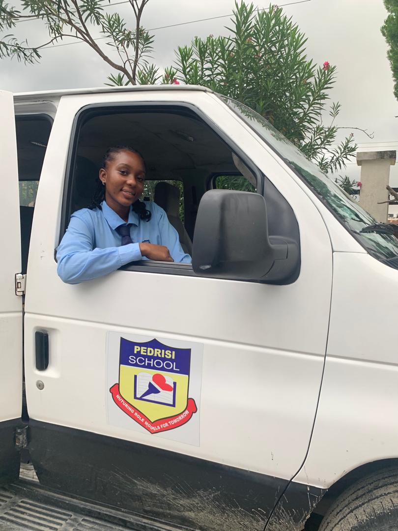 Pedrisi student smiling from the school van