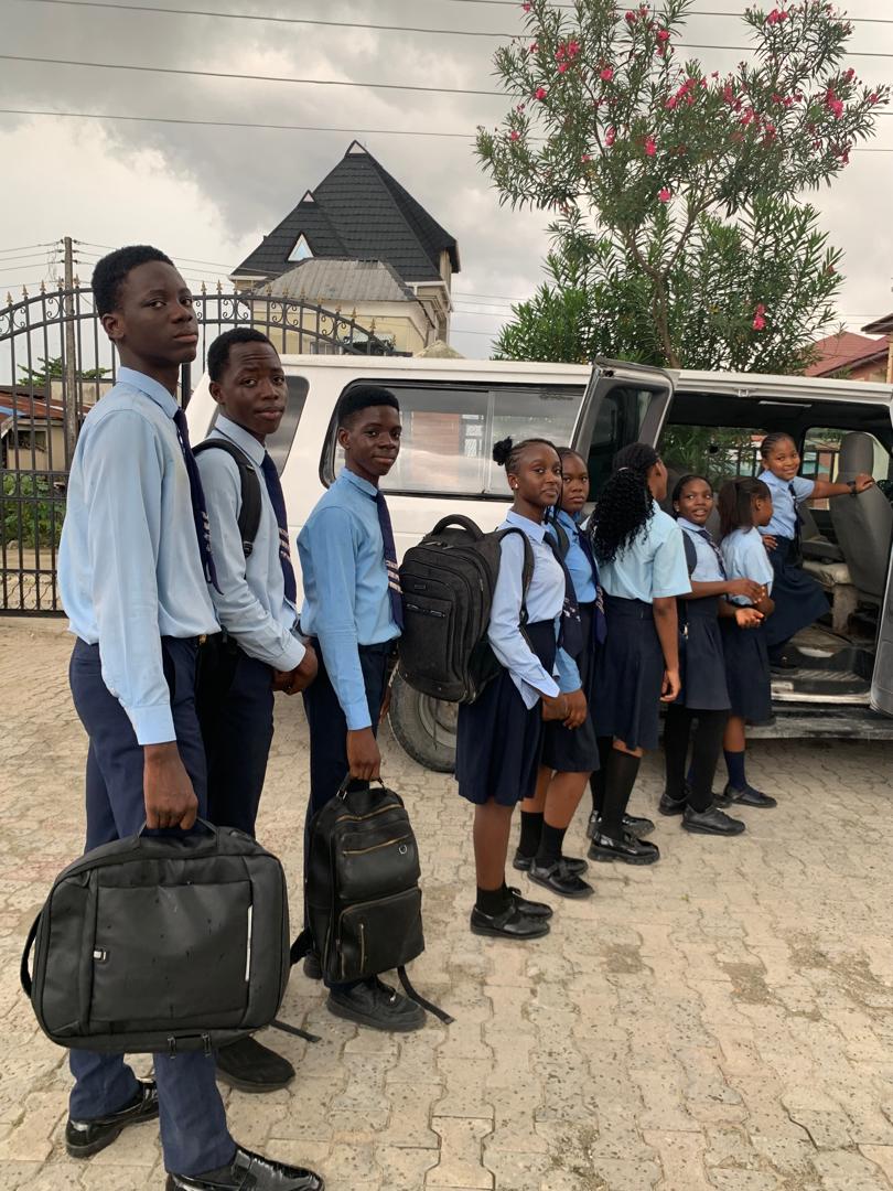 Pedrisi students lined up beside the school van